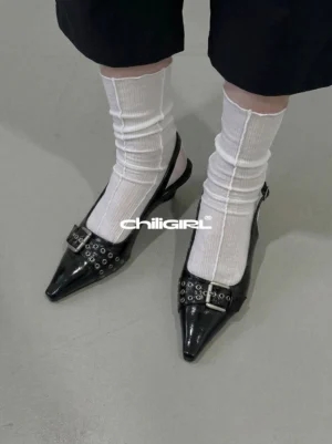 Black pointed-toe slingback kitten heels with silver rivet buckle hardware styled with white ribbed crew socks