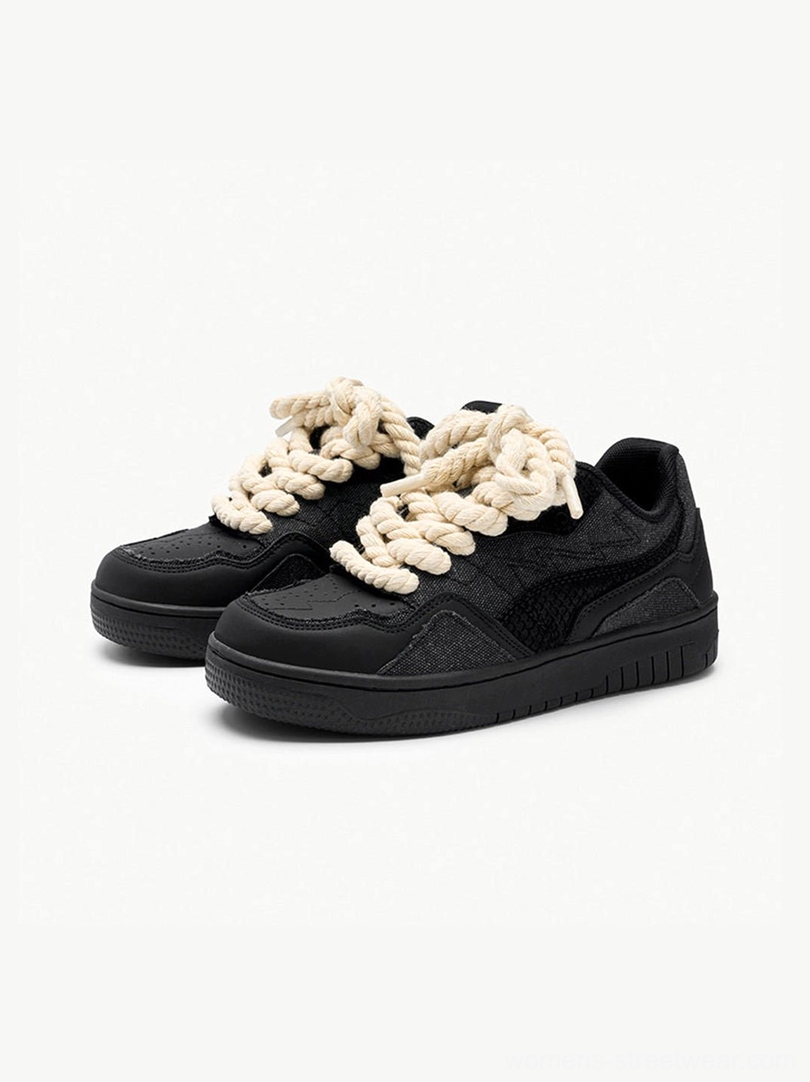 Pair of black low-top streetwear sneakers with thick cream twisted rope laces viewed from above