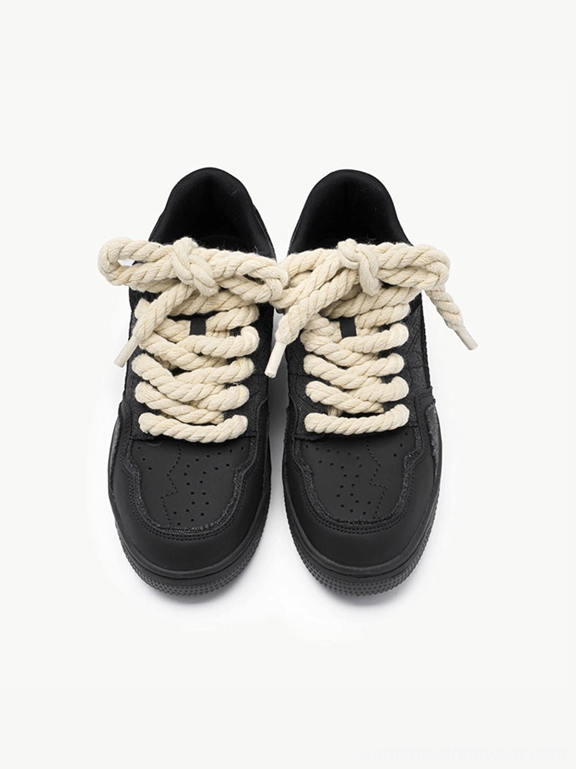 Top front view of black rope lace low-top streetwear sneakers showing perforated toe caps