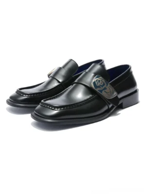 Front view of polished black rose crest leather loafers with sculpted square toes and vivid blue leather lining