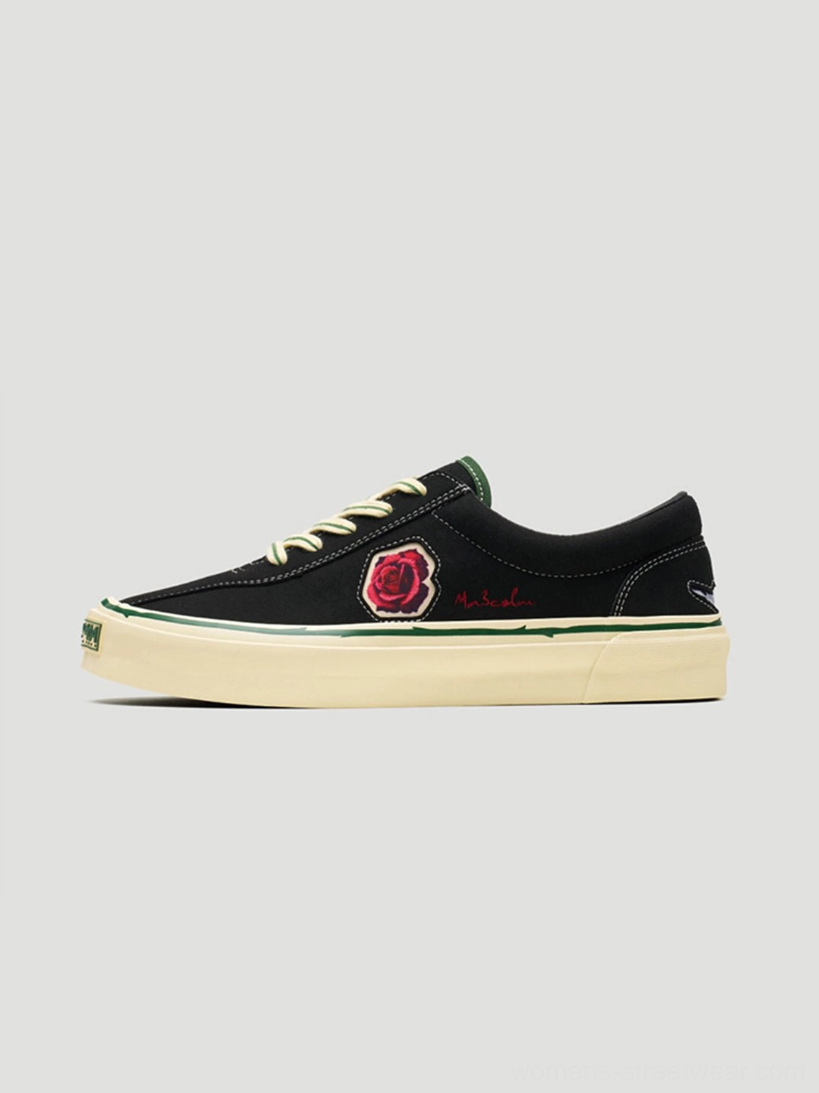 Black rose embroidered low-top skate shoes with textured upper, contrast laces, red floral side embroidery, and vintage off-white rubber sole
