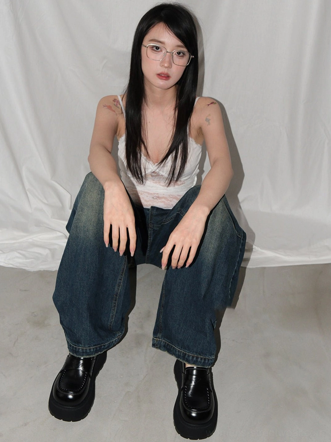Black rounded-toe platform loafers paired with white camisole and wide-leg denim for a retro Y2K casual outfit