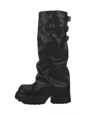 Black ruched buckle knee-high chunky platform boots in matte faux leather shown from the front left on a white background