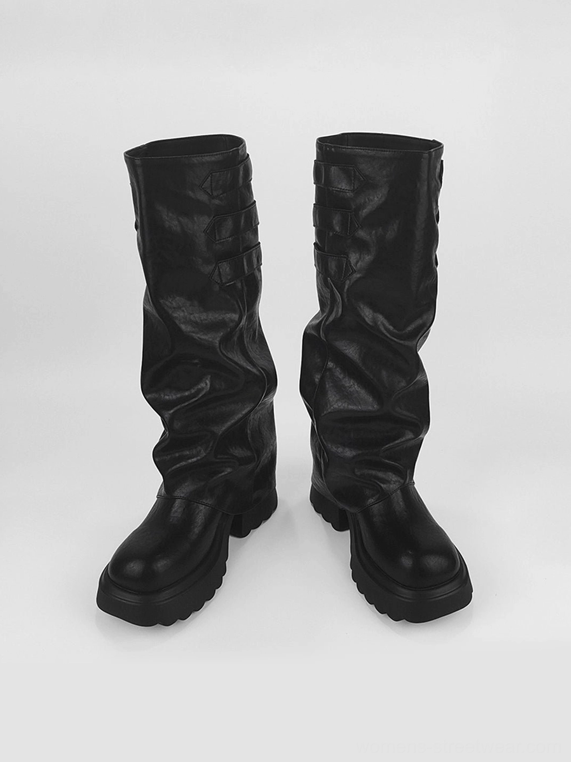 Front view of black ruched knee-high chunky platform boots showing rounded toes, matte faux leather, and thick platform soles