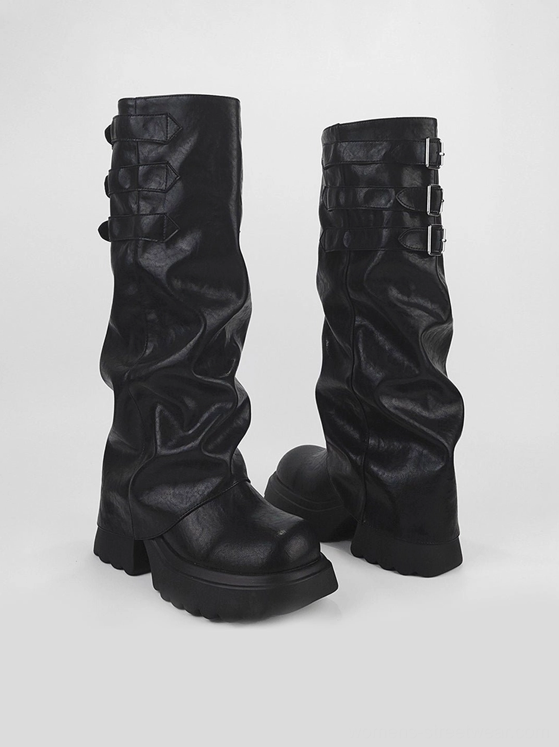Side product view of black ruched shaft platform boots highlighting the slouchy calf, buckle straps, and chunky outsole