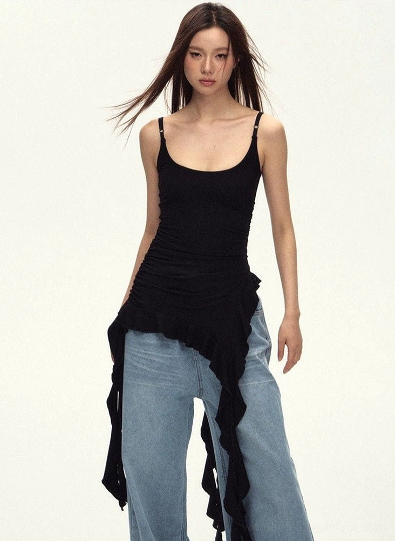 Front view of a black ruched cami top featuring gathered fabric and long flowing asymmetric ruffle tails