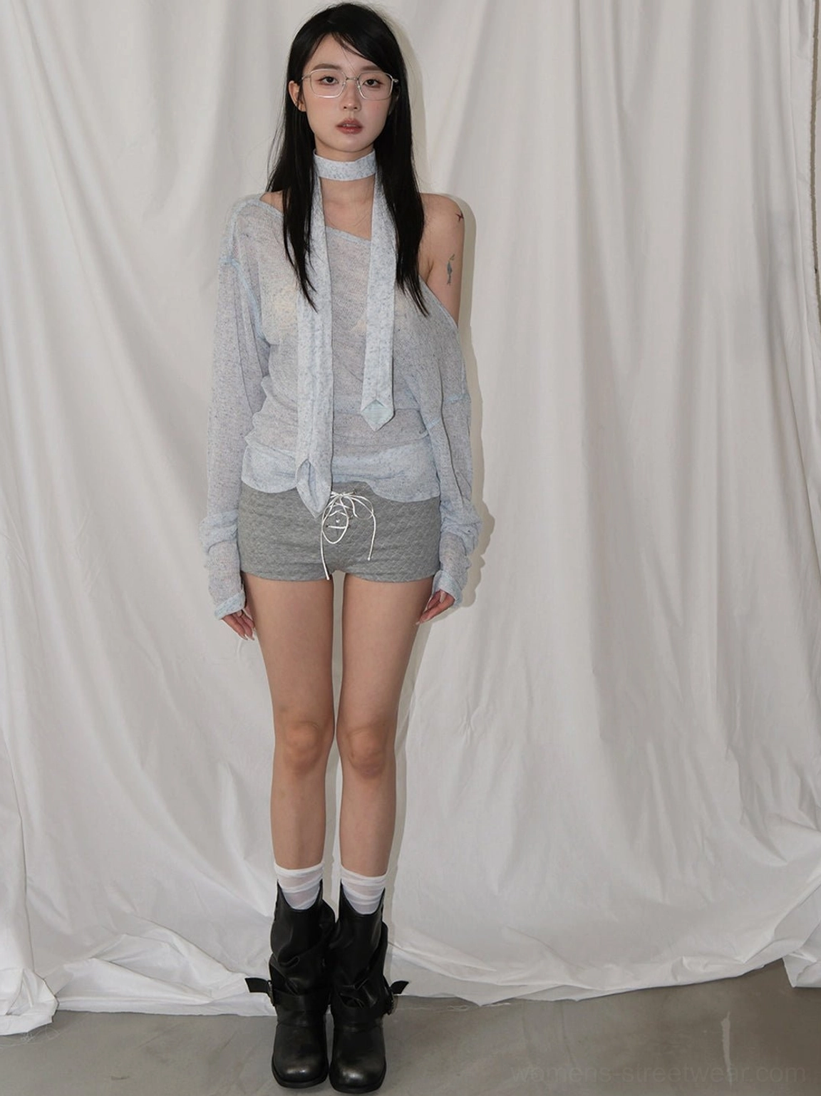 Black ruched mid-calf block-heel streetwear boots shown with layered grey knitwear and casual shorts