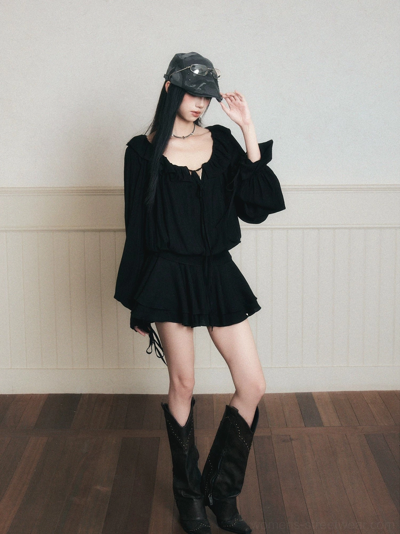 Black ruffle poet mini dress set with tie-front ruched neckline, flared sleeves and western boots in vintage studio