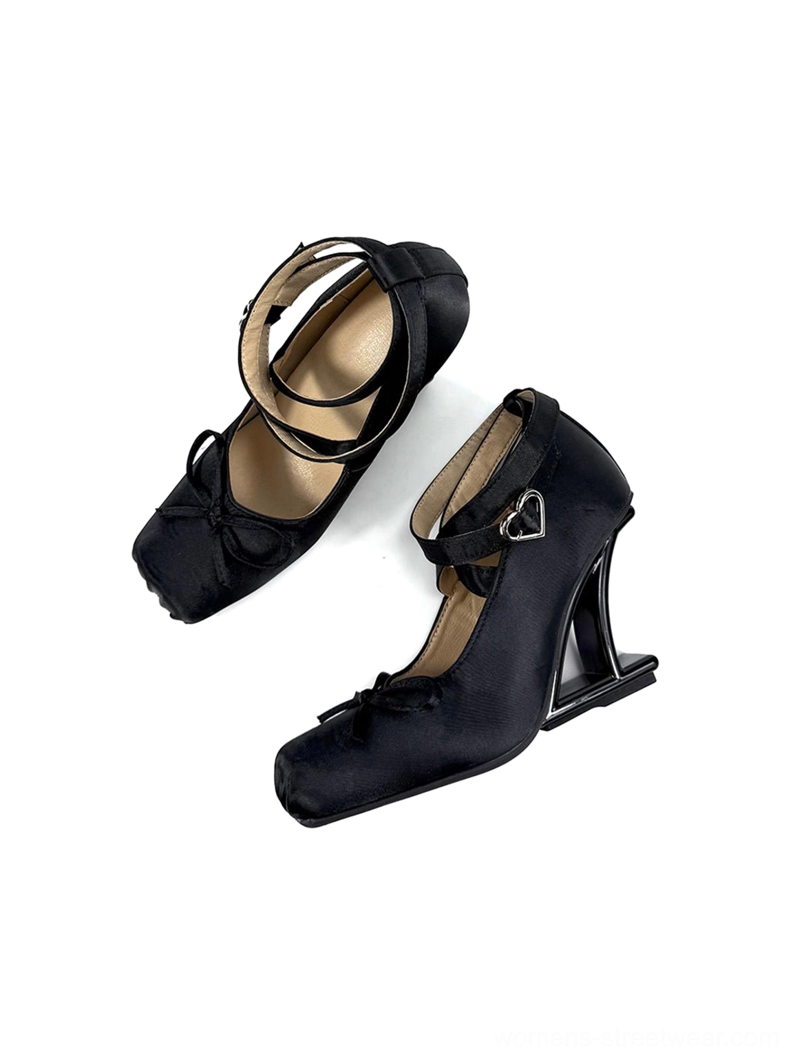 Rear three-quarter view of black satin bow pumps with heart-shaped ankle buckles and an avant-garde wedge-style heel