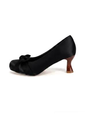 Black satin-look bow pumps with rounded closed toe and sculpted wood-look cup heel shown in a left side product view