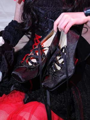 Black satin Mary Jane high heel pumps with long crisscross ribbon laces styled with a gothic Lolita red tulle dress and corset