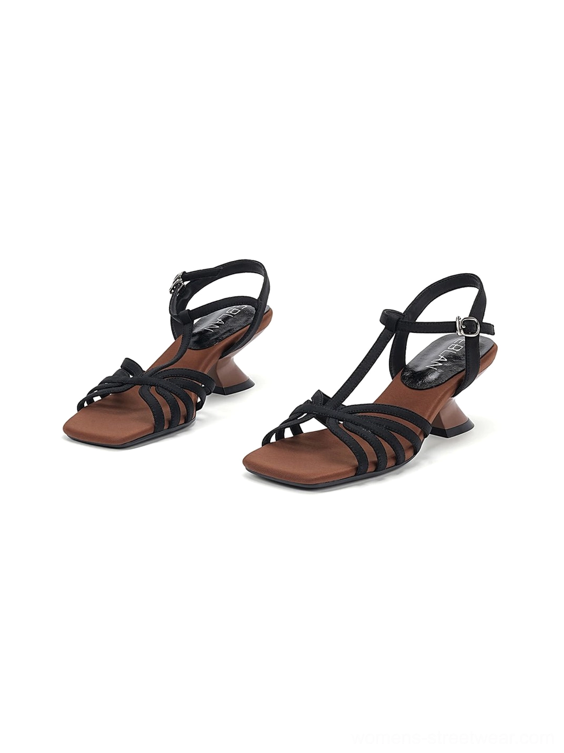 Low overhead view of black sculptural cone heel sandals showing the slim heel profile and compact paired silhouette