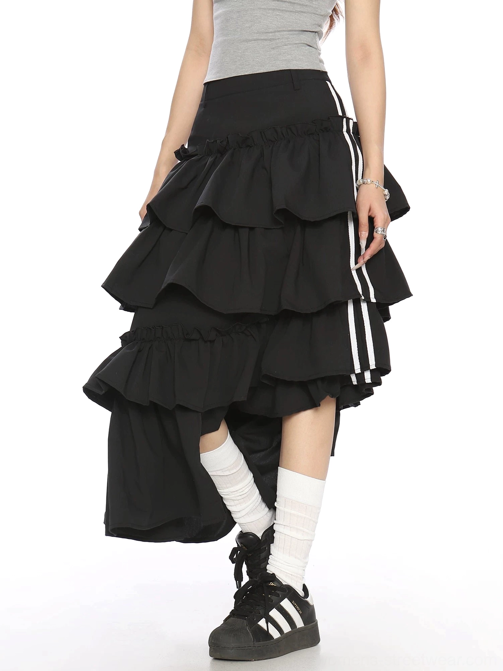 Side front view of black sculptural tiered ruffle midi skirt featuring contrast striped ribbon ties and uneven hem