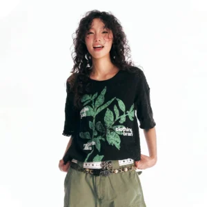 Black sesame leaf burnout graphic T-shirt with distressed hollow-knit texture, green botanical print, and oversized Korean streetwear styling