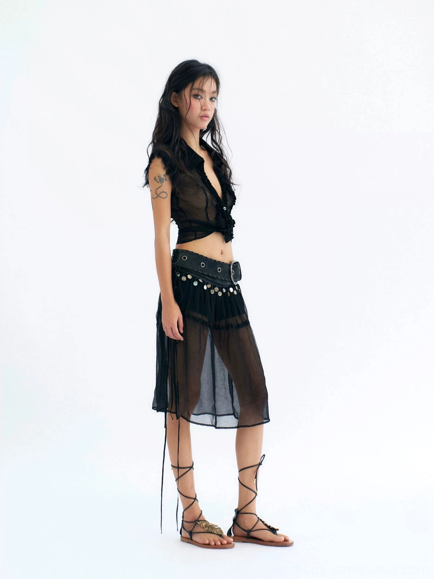 Black sheer coin belt midi skirt with cotton shorts styled in a dark Y2K festival outfit front view