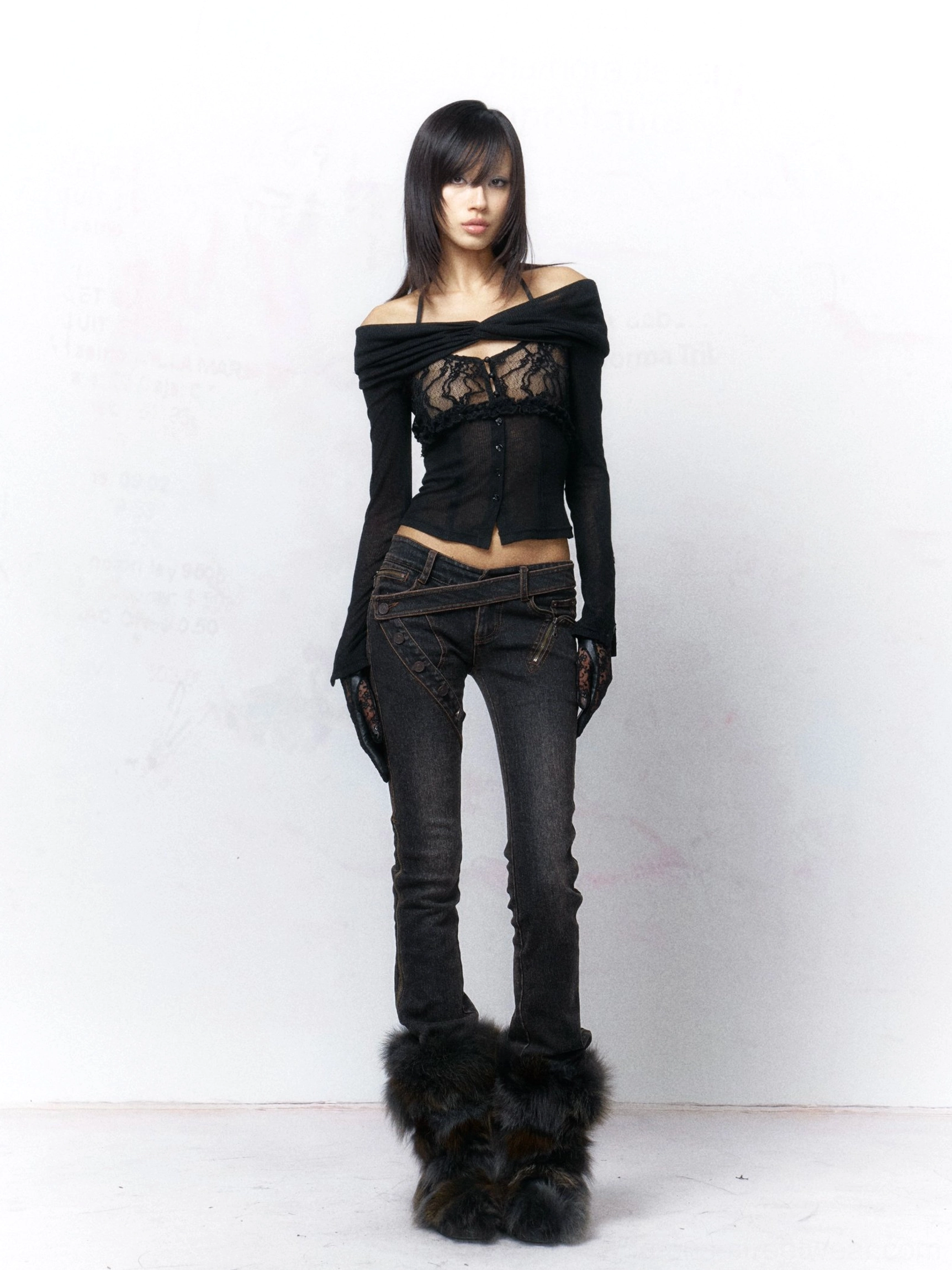 Black sheer lace off-shoulder cardigan styled with low-rise black denim, fitted waist, long sleeves, and matching sheer gloves for a Y2K clubwear outfit