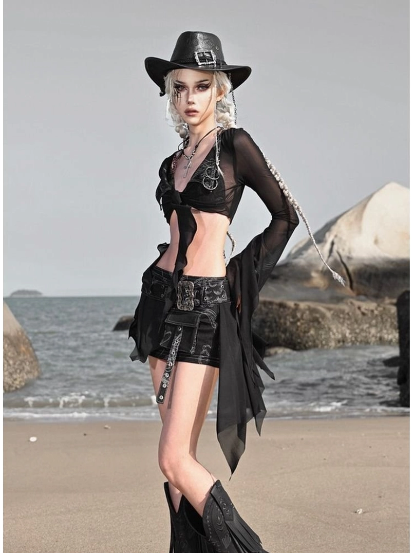Side view of a black sheer mesh short cardigan with long flare sleeves, tie-front styling, distressed shorts, and body chain detail
