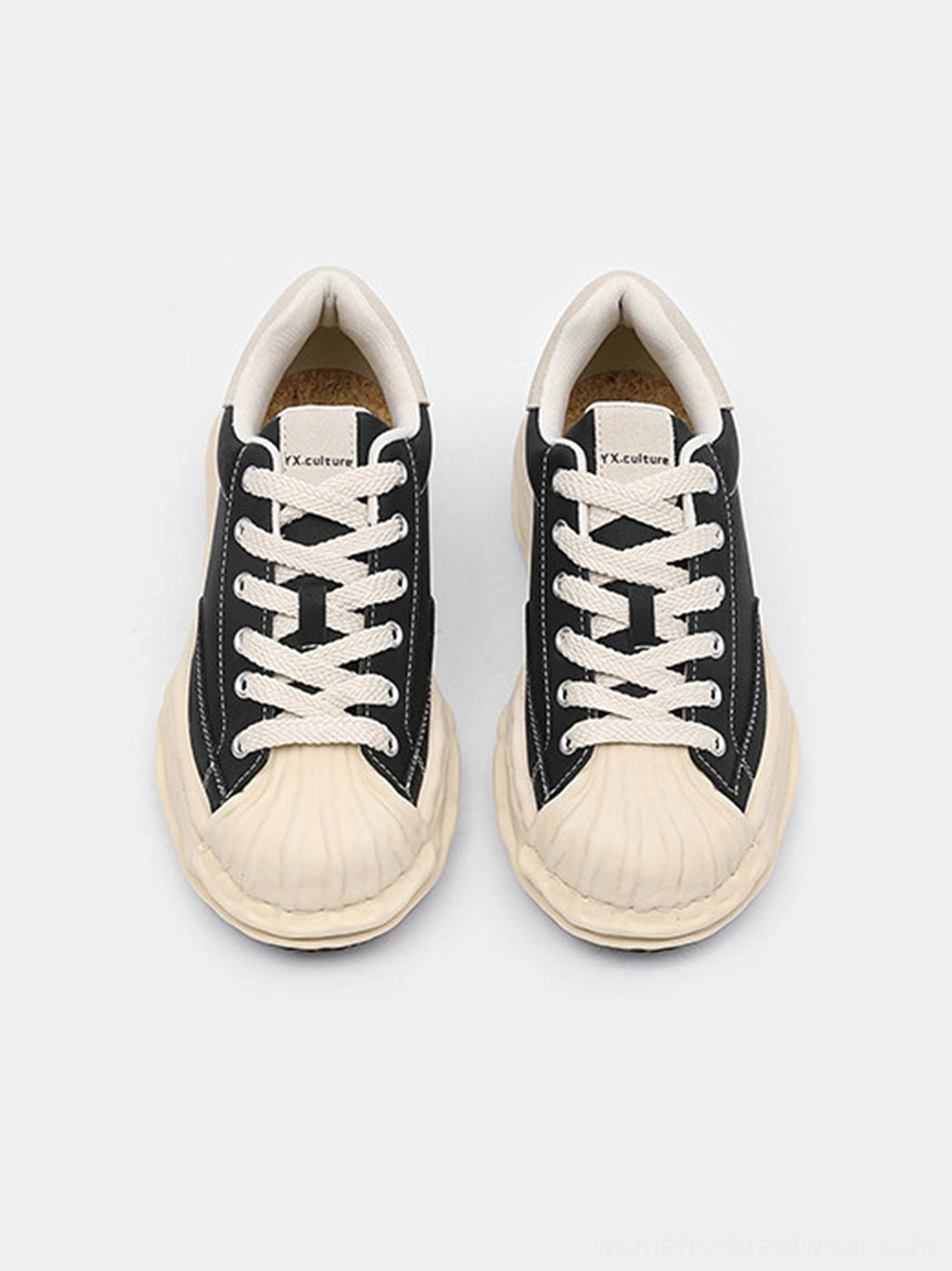 Black shell-toe platform sneakers with thick lifted soles styled for modern Acubi fashion, wide-leg denim, and relaxed streetwear