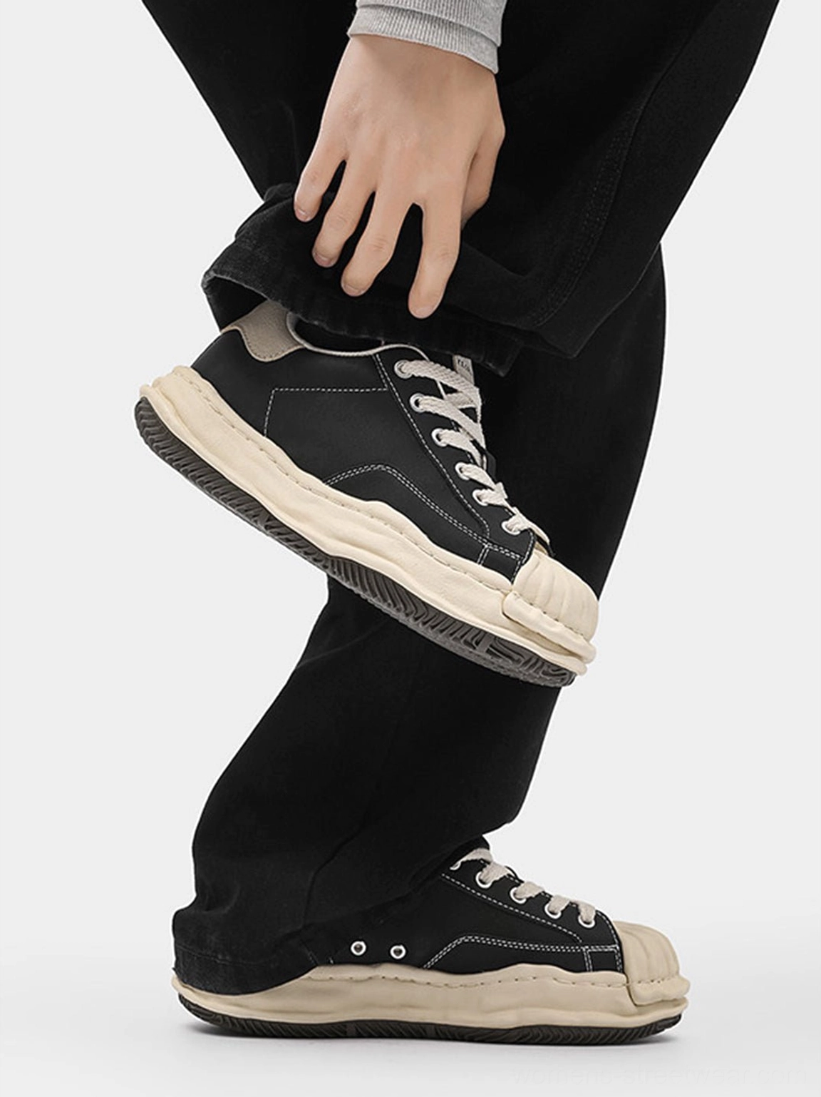 Black shell-toe platform sneakers highlighting the clean black-and-cream colorway, substantial sole, and contemporary casual styling