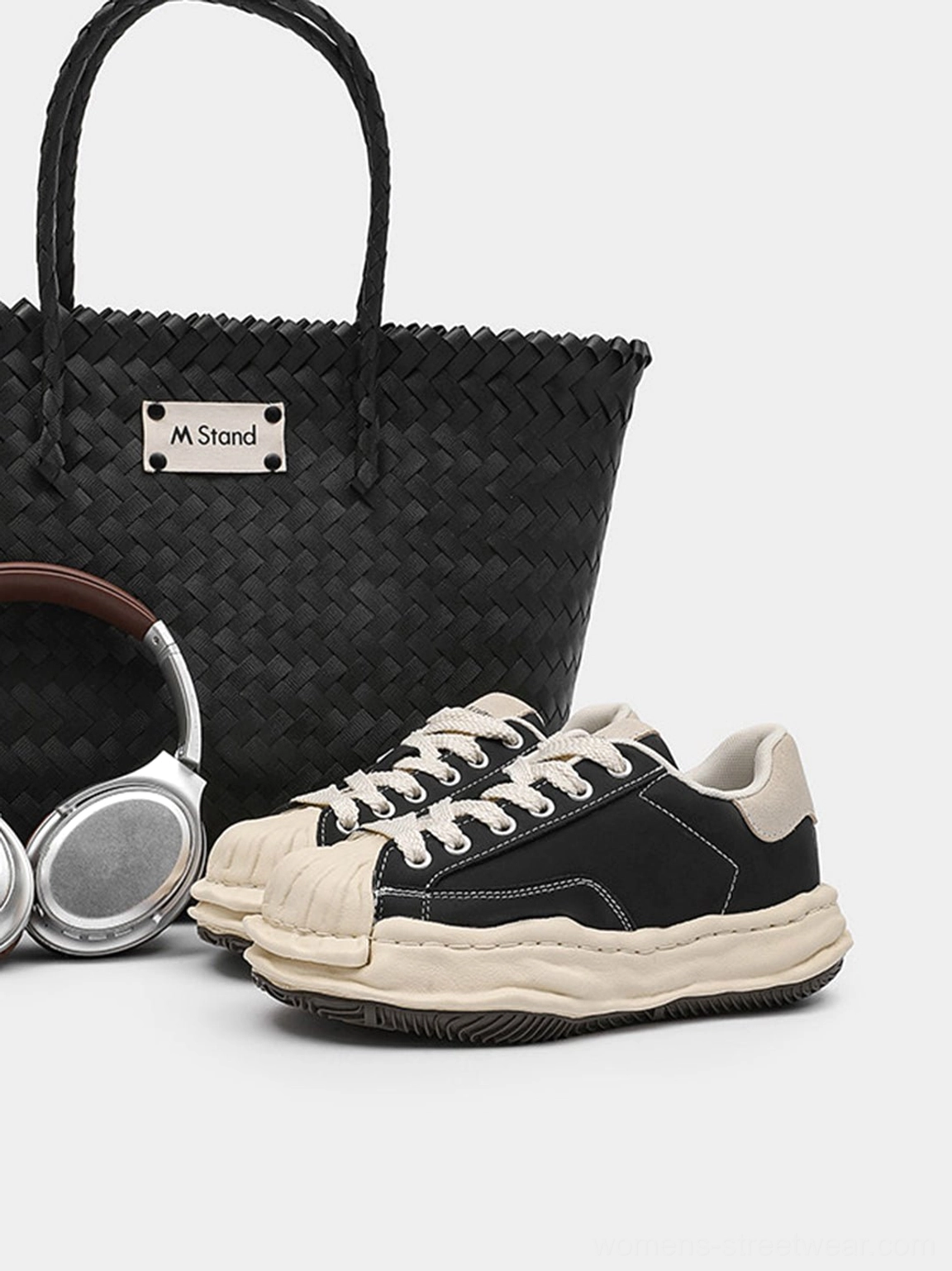 Black shell-toe platform sneakers product detail view featuring the contrasting cream toe and elevated streetwear sole