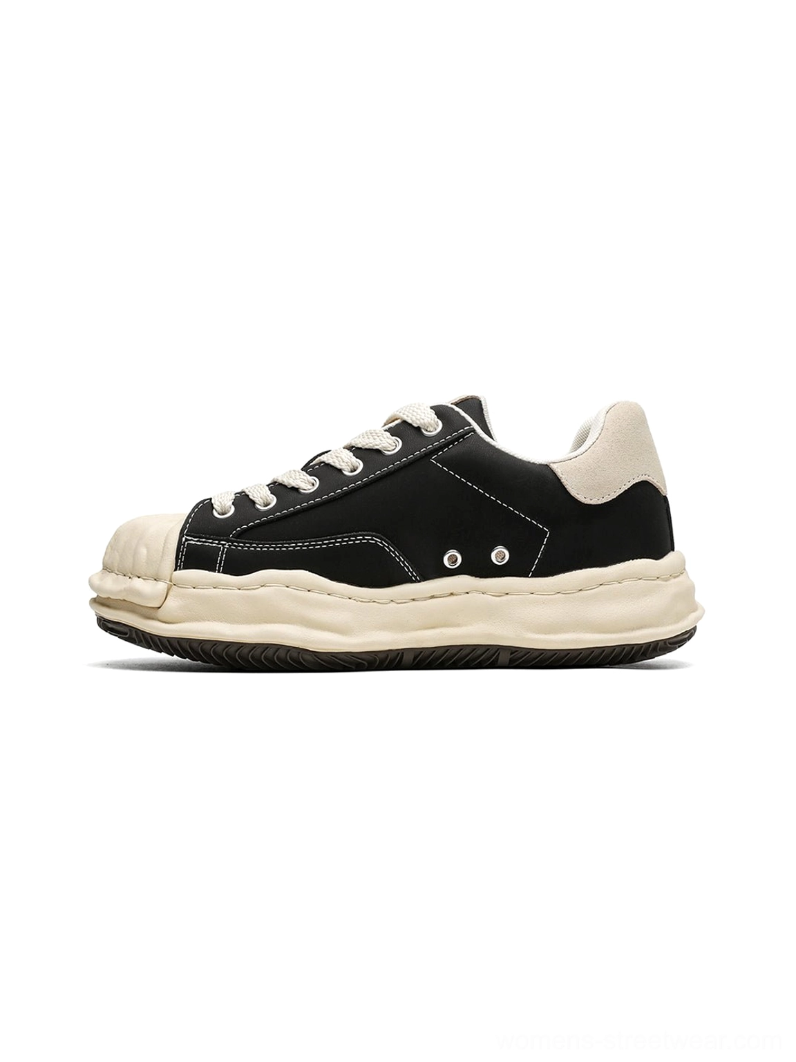 Black shell-toe platform sneakers shown from a left front angle with a cream rubber toe, thick lifted sole, and classic lace-up streetwear design