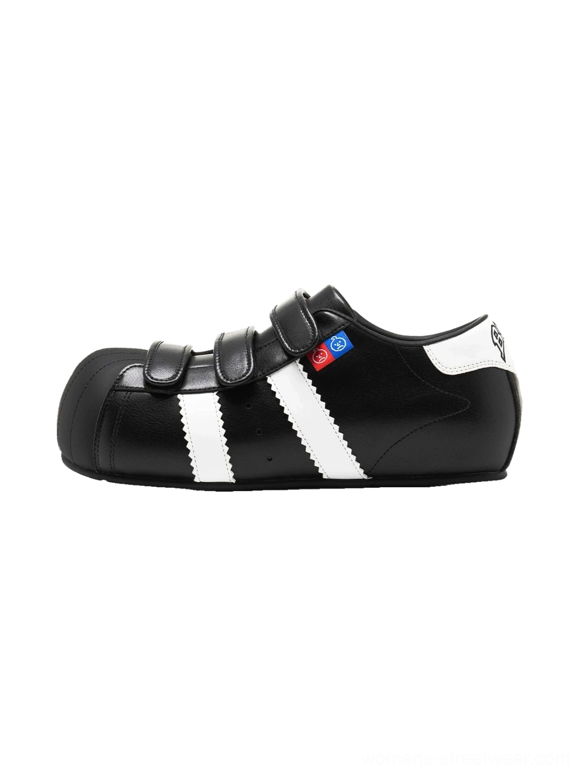 Black shell toe strap sneakers with white contrast side stripes, hook-and-loop fastening, and hidden lift