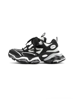 Black silver chunky runner sneakers in a left side three-quarter view, showing layered leather panels, contrast detailing, lace-up front, and thick air-cushioned outsole