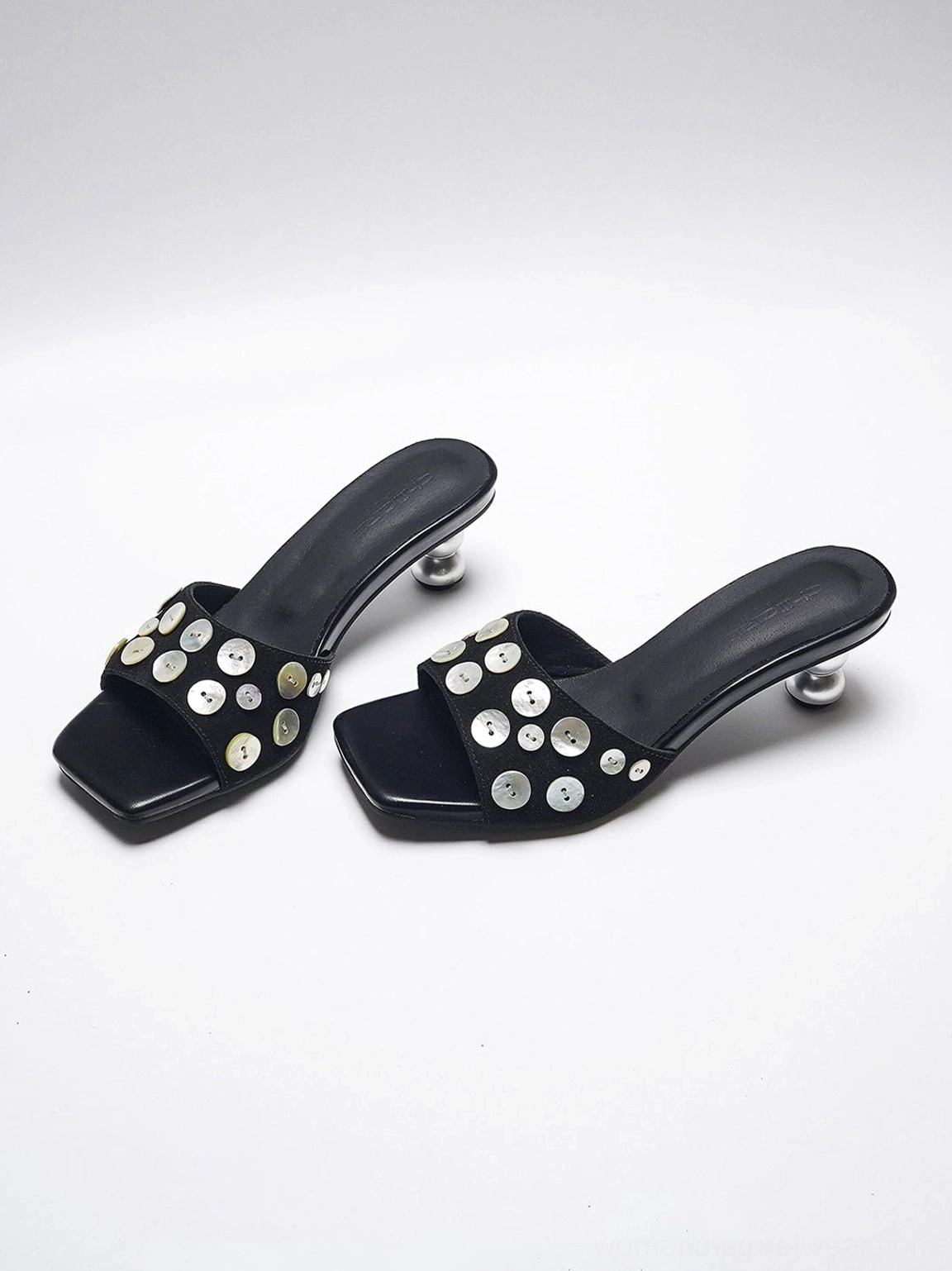 Black silver embellished high heel slides showing square toe and sculptural polished heel detail