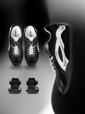Black and silver low-profile racing sneakers with suede contrast panels, metallic side stripes, lace-up front, and slim rubber sole studio product view