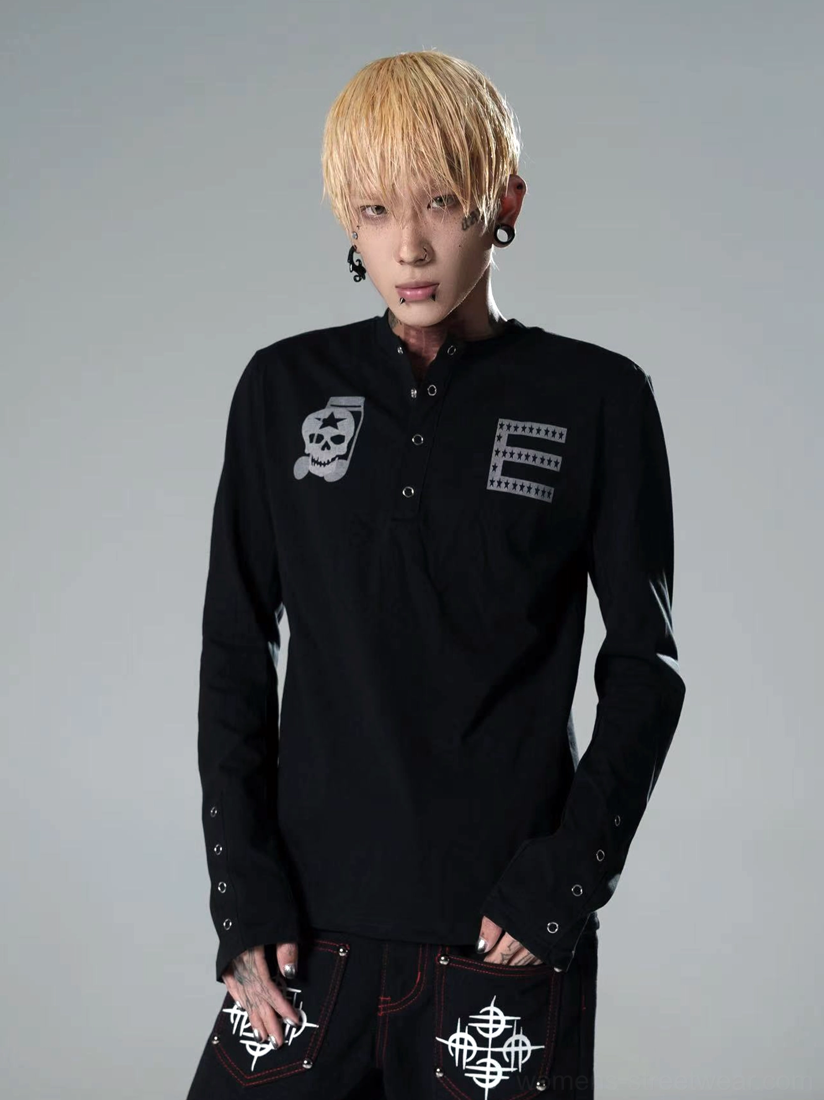 Black skull graphic Henley long sleeve streetwear top on a model featuring tonal chest artwork, half snap-button front, slim fit, and detailed cuffs