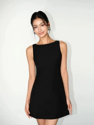Front view of a black sleeveless boat neck shift mini dress with fitted waist and A-line silhouette