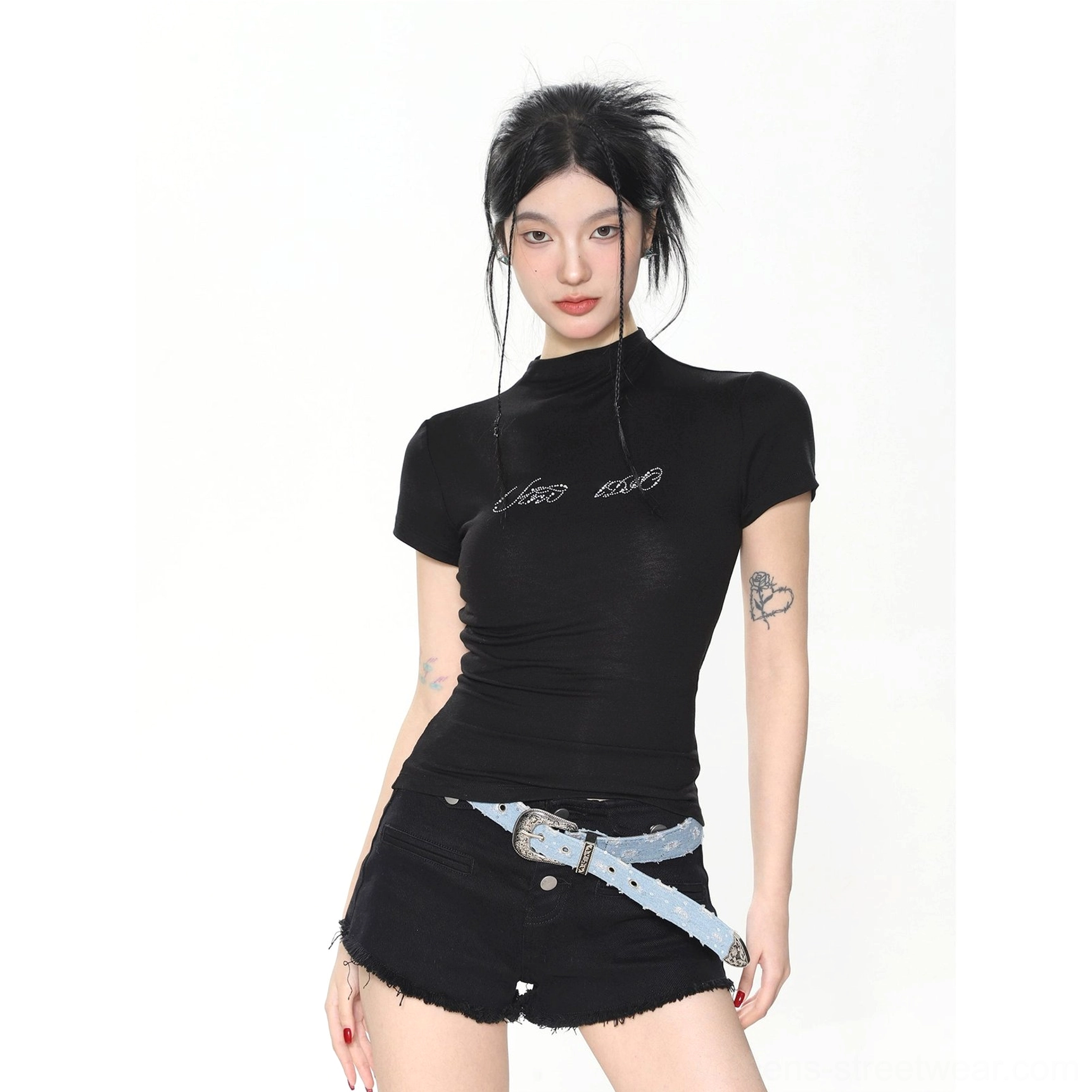 Close view of black slim fit mock neck baby tee featuring a small embroidered chest logo and fitted silhouette