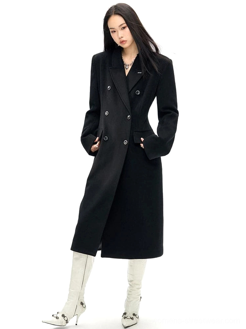 Black slim waist wool overcoat in three-quarter front view with double-breasted buttons and flap pockets