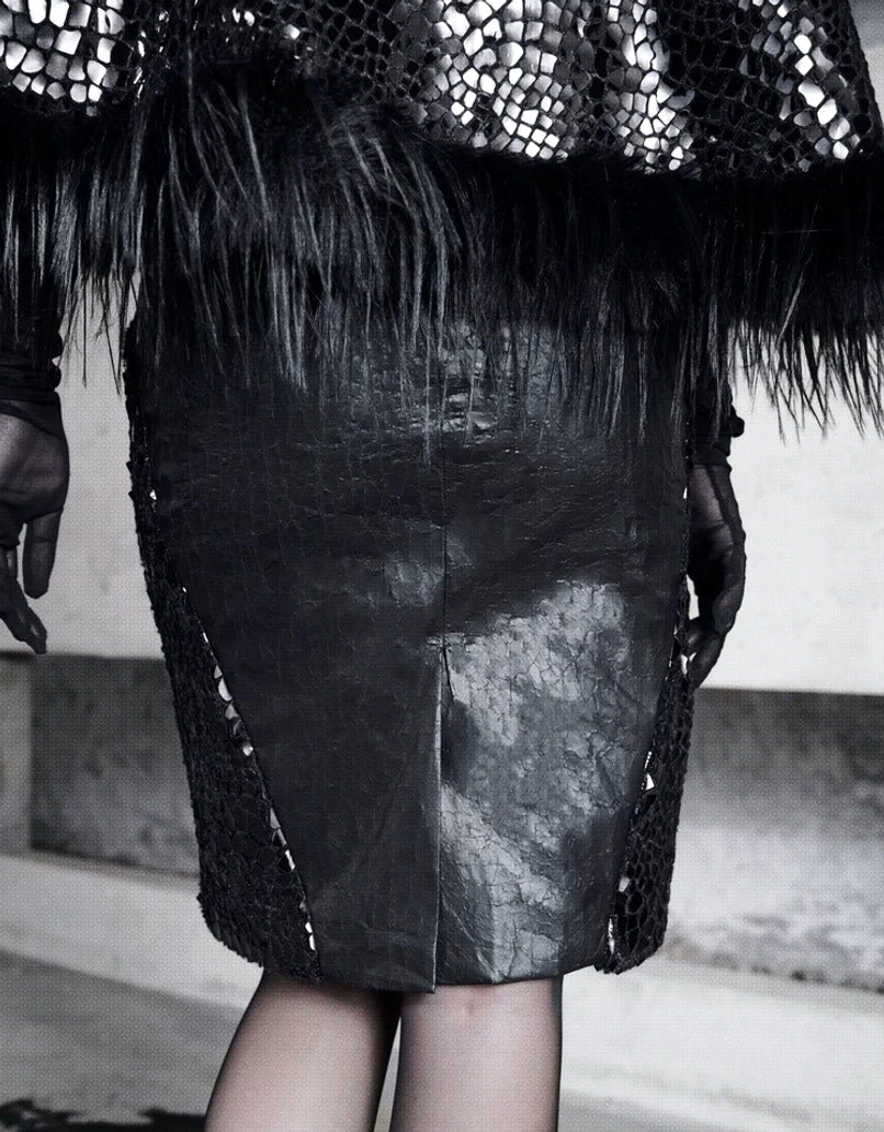 Rear side close-up of black faux fur waist trim and snakeskin mesh panel on high-waist gothic pencil skirt