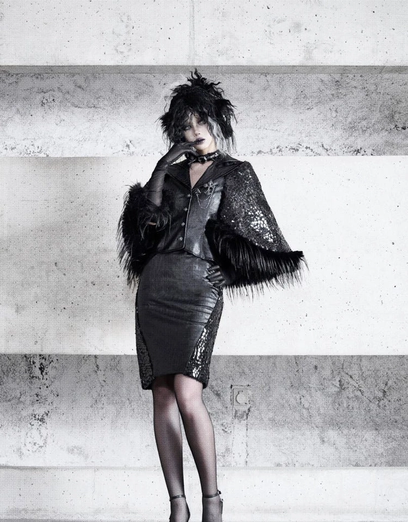 Front full-body styling of black faux leather pencil skirt with snakeskin mesh side panels and dramatic faux fur hip detail