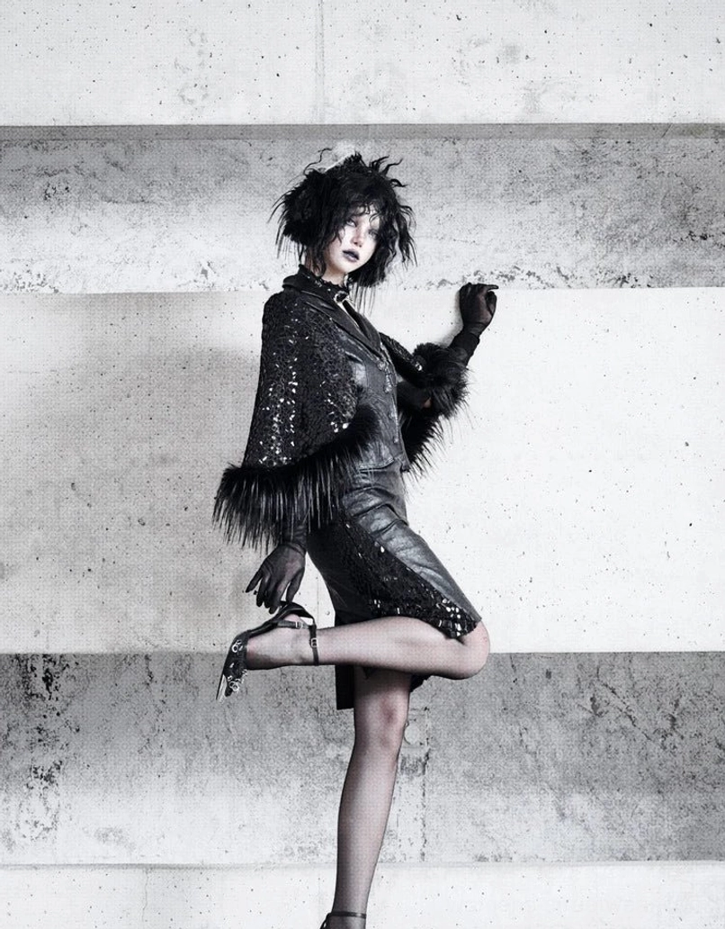 Side full-body view of black high-waist snakeskin mesh pencil skirt with faux fur trim in a gothic Seoul streetwear look