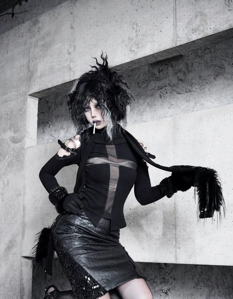 Three-quarter front view of black high-waist pencil skirt with snakeskin mesh side panels and faux fur waistband trim