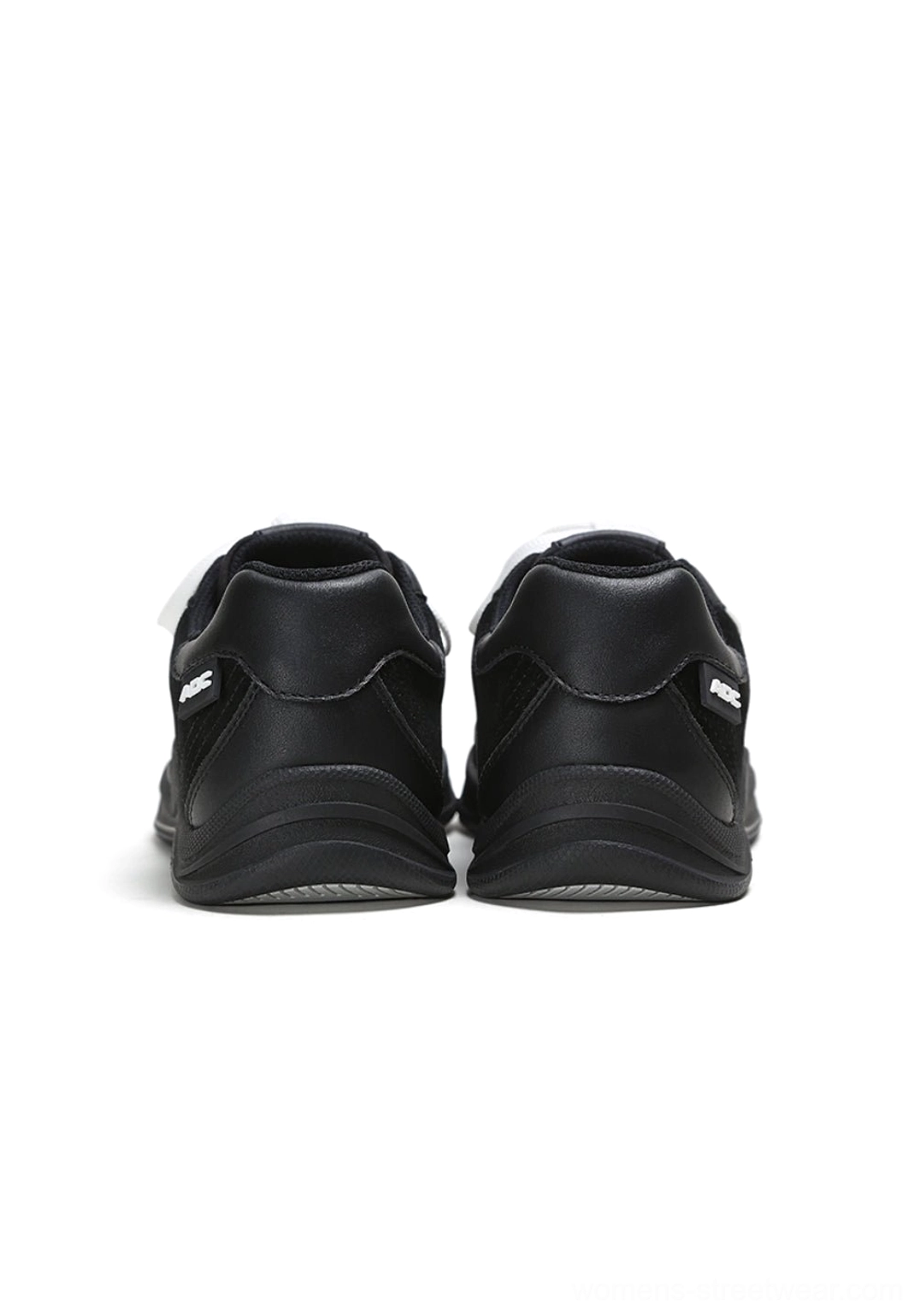 Rear view of black leather solar star court sneakers showing smooth heel counters and structured low-top construction