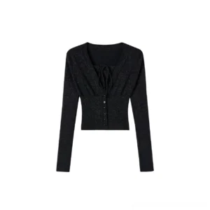 Flat lay front view of a black sparkly cropped knit top featuring faux two-piece halter styling, ruched bust, front buttons and fitted long sleeves