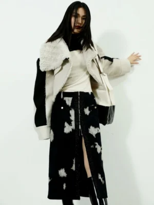 Women's black speckled corduroy midi skirt with front zipper slit styled with a matching shearling trim coat