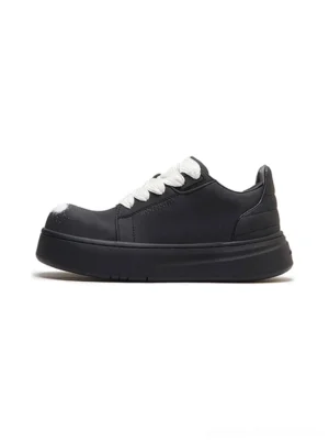 Black spray-finish platform derby shoes with oversized white laces and chunky rounded rubber soles shown in a clean side product view