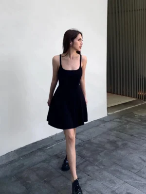 Black square neck A-line mini dress side profile showing fitted bodice and flared skirt