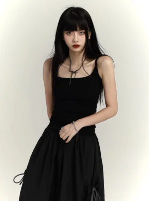 Black square neck fitted camisole tank top with spaghetti straps shown in a front three quarter studio view