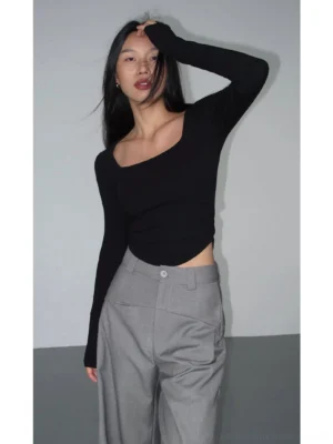 Black fitted square neck crop top with long sleeves and ruched side hem detail shown in a three-quarter Korean streetwear outfit view