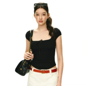 Black square neck puff sleeve corset crop top with gathered bust and front bow styled with white pants