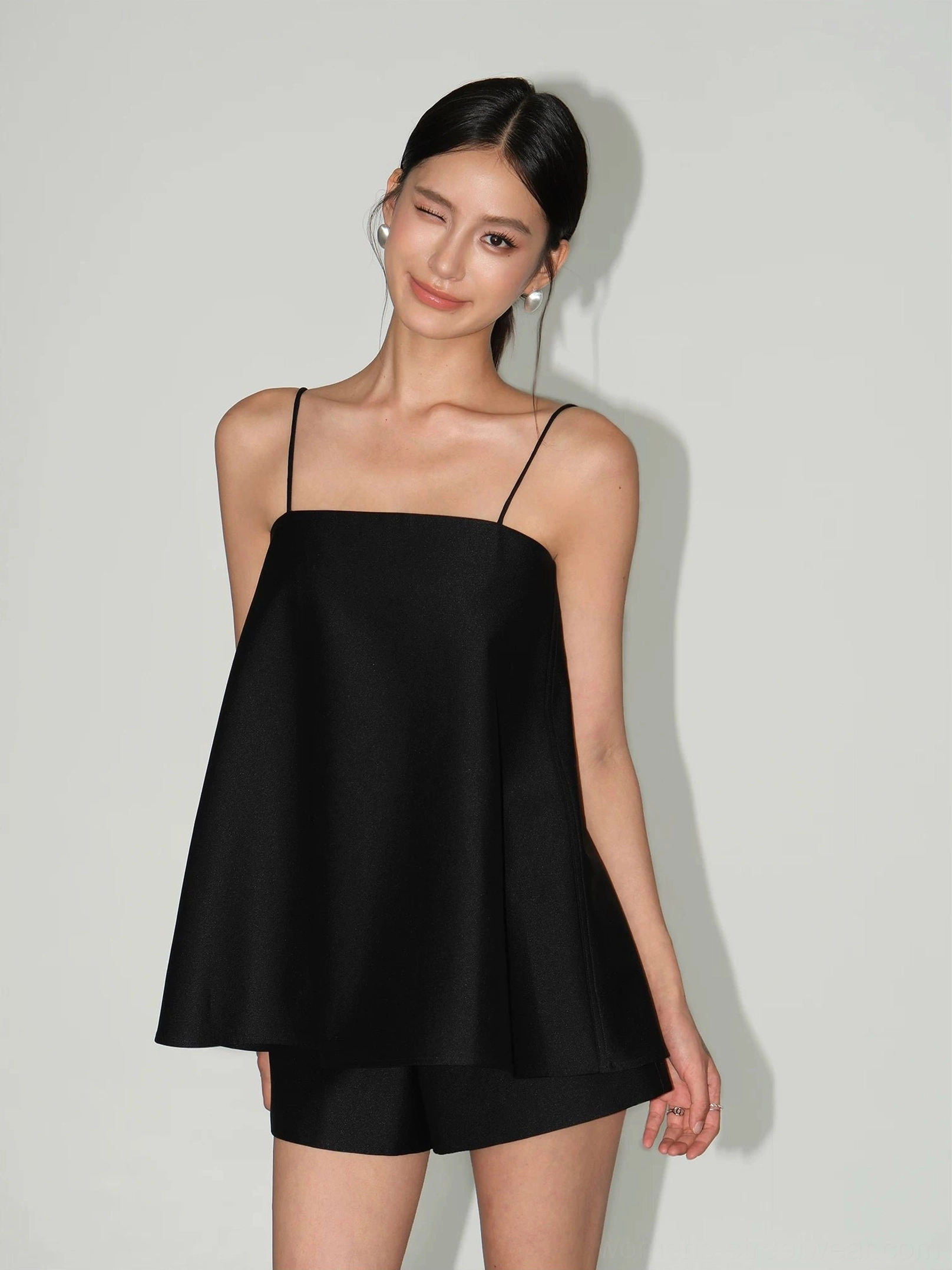 Black square neck spaghetti strap A-line cami top with tailored shorts close-up