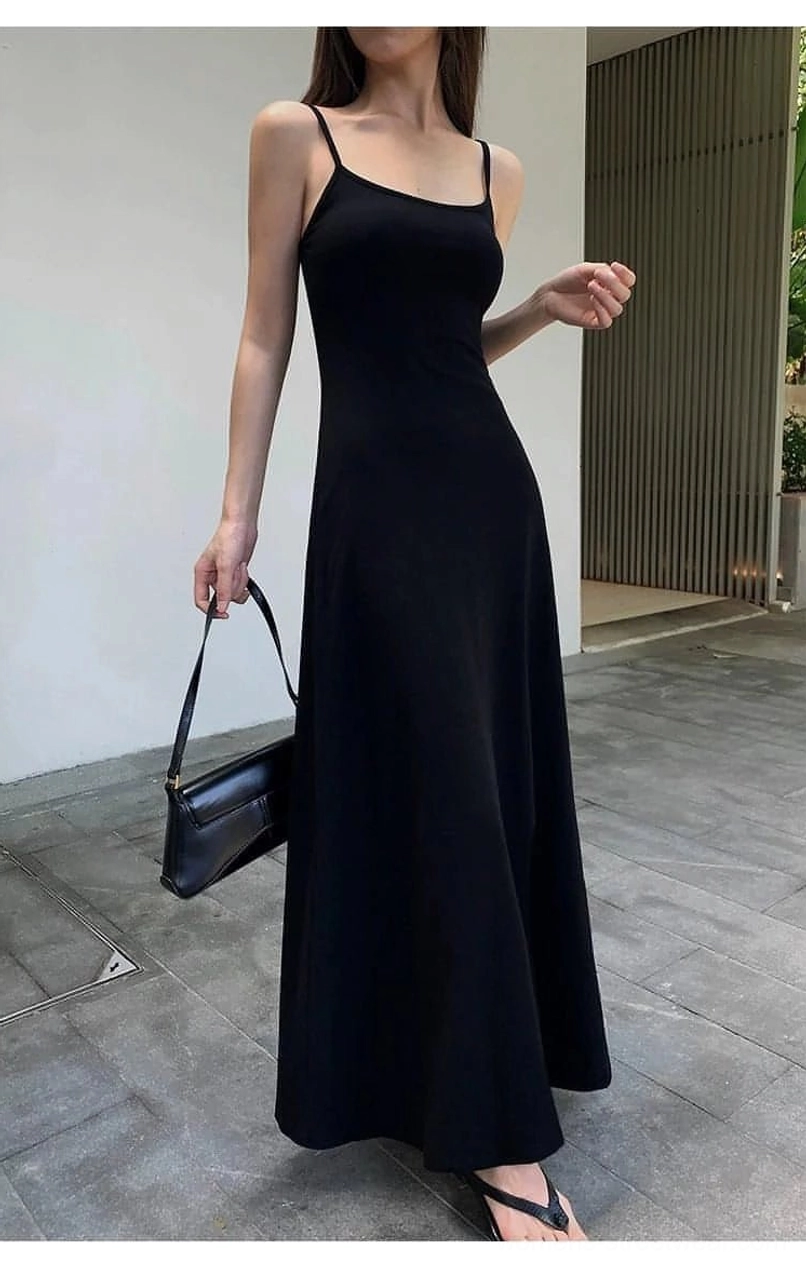 Black square neck spaghetti strap maxi dress shown from the front side with a leather handbag