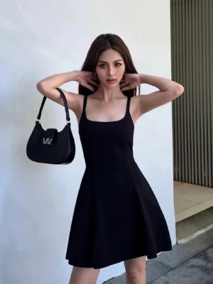 Black square neck tie-back A-line mini dress front view styled with a black handbag