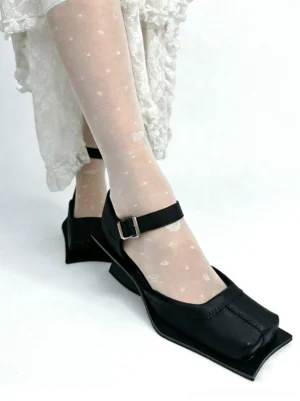 Black square-toe block-heel sandals styled with heart-pattern sheer stockings and a white lace midi skirt in Seoul streetwear fashion