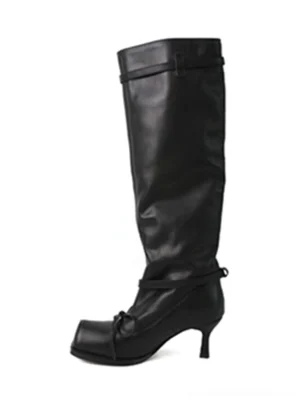 Black square-toe bow knee-high leather boots shown in a frontal flat lay view with smooth leather, ballet-inspired bow strap, relaxed shaft, and elegant low heel